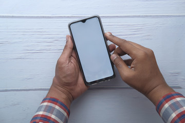 Man using smartphone with blank white screen