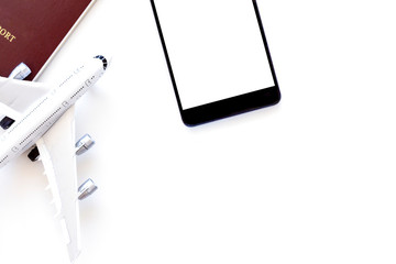 Summer holiday vacation travel concept. Mock up image of passport, digital tablet with blank screen and airplane model isolated on white  background. Top view. 