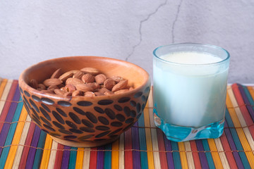 Close up of fresh almond and milk on table 