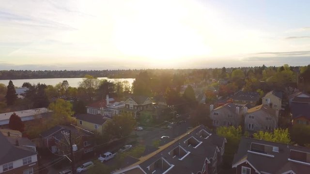 Aerial flight over outlying area of Seattle during a golden hour sunset 