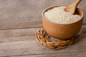 White rice and paddy isolated on wood table.