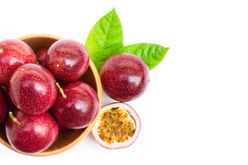 passion frui in wooden bowl isolated on white background .