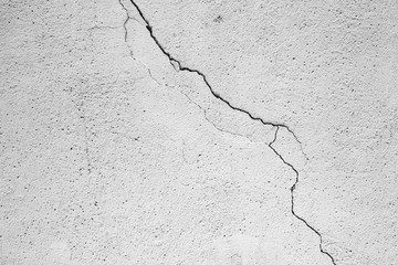 Cement concrete wall texture, white, old, background with a cracked wall.