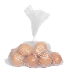 Raw chicken egg in a package on a white background.