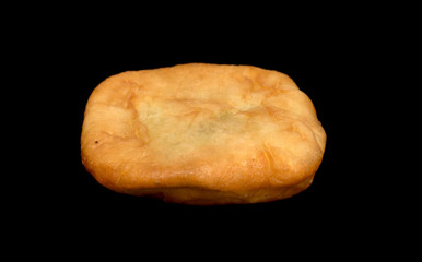 Fried pies isolated on a black background.