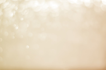 Abstract bokeh sparkle on yellow and gold background