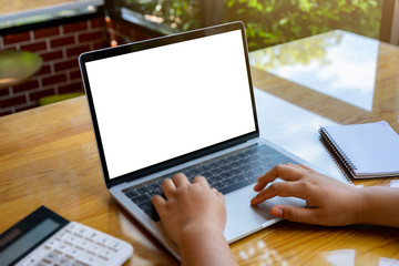 Blank screen laptop computer on wood table with clipping path. business concept. Mockup with copy space.