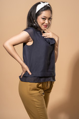 Asian woman with retro outfit on pastel background