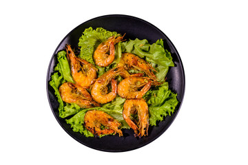 Plate with grilled shrimps and lettuce leaves isolated on a white background
