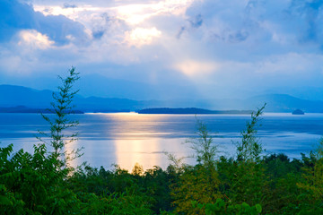 Obraz na płótnie Canvas Sunrise in the morning after the rain on lagoon and mountain