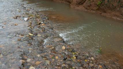 River water flow in the rainy season, looks clear and fresh depicts a rural atmosphere