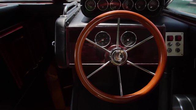 close up of old fashioned steering wheel in yacht boat control deck with different navigation implement