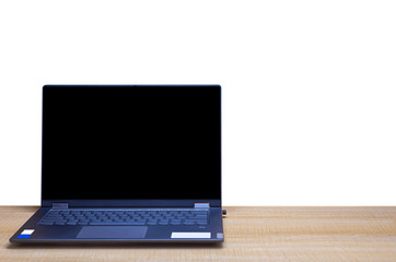 A notebook computer placed on a wooden office desk and isolated on white background with clipping path