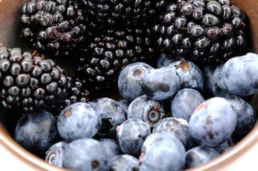 Blueberry and Blackberry on blown cup with white background, fruit concept