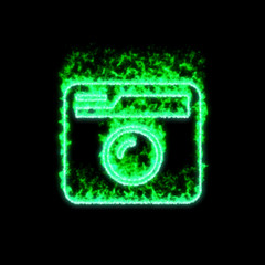 The symbol camera retro burns in green fire
