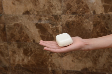 A boy holding a bar of soap. Washing hands is an important step in the prevention of the cover-19...