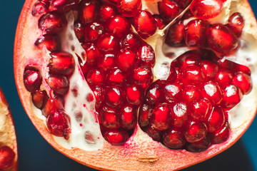 Fresh red cut pomegranate with berries. Close up.Healthy eating. Macro photography.