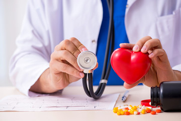 Young male doctor cardiologist working in the clinic