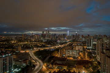 Fototapeta premium Aerial Panoramic view of Kuala Lumpur with rain clouds during night time.