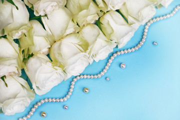 Bouquet of white roses with pearls on white-blue background. For greeting cards, banners and covers