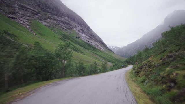 Fast Motion of a Spectacular narrow valley road in norway - Going down to the fjord