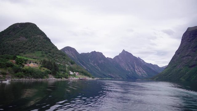 looking in the breathtaking fjord from a ferry boat in the norwegian sum&oslash;rsalpene - magnificent scenery on a cloudy day