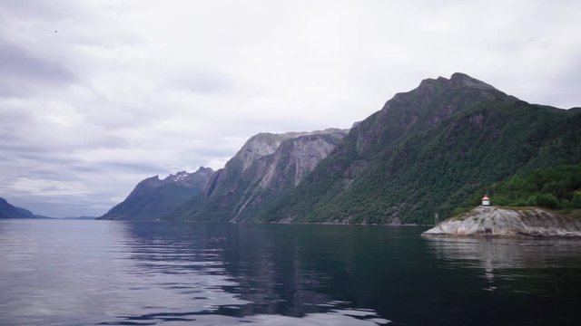 view down the breathtaking fjord from a ferry boat in the norwegian sum&oslash;rsalpene - magnificent scenery on a cloudy day
