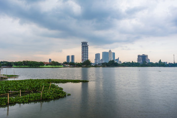 Tangerang, Indonesia - 5th January 2018: A view of Danau Kelapa Dua (Kelapa Dua Lake) on the foreground and Lippo Karawaci district buildings in the background. Taken in a cloudy afternoon.