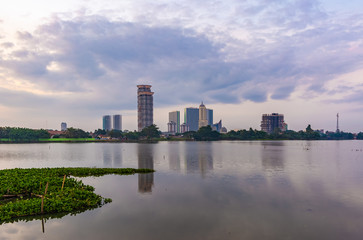 Tangerang, Indonesia - 5th January 2018: A view of Danau Kelapa Dua (Kelapa Dua Lake) on the foreground and Lippo Karawaci district buildings in the background. Taken in a cloudy afternoon.