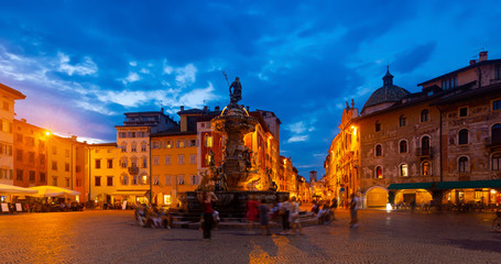 Fountain of Neptune on Piazza Duomo in Trento at twilight