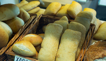 Baked baguettes on showcase in bakery shop