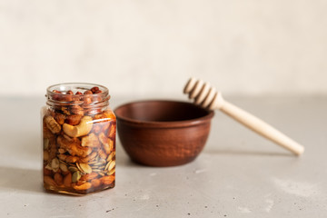 Mix of kernel And A Jar Of Golden Light Honey With A Honey Dipper