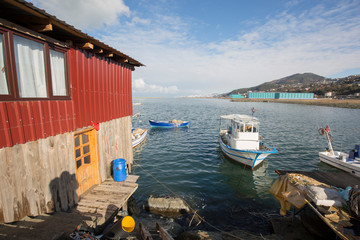 Fototapeta na wymiar fishing boats and huts in the harbor