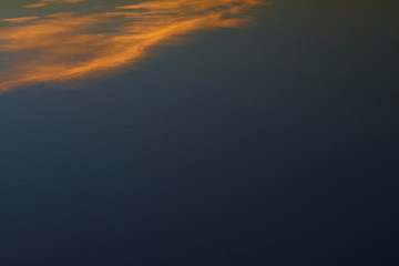 evening clear blue sky with orange sunlight shine through cloud