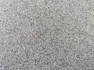 Top view of texture fine sand beach. Beautiful grey sand surface for backgrounds and wallpapers