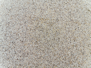Top view of texture fine sand beach. Beautiful gray sand surface for backgrounds and wallpapers