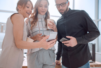 business team reading emails on their smartphones.