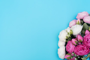 Pink and white flowers on blue background. Mother’s Day, Spring concept. Greeting, invitation card. Flat lay, top view style with copy space for your text.