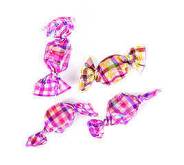 candies wrapped in colored foil on white background