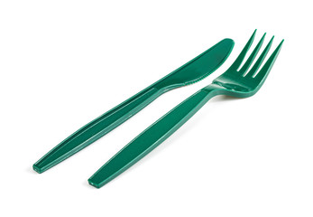 Green plastic knife and fork isolated on white background