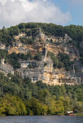  Canoeing and tourist boat, in French called gabare, on the river Dordogne at La Roque-Gageac, Aquitaine, France