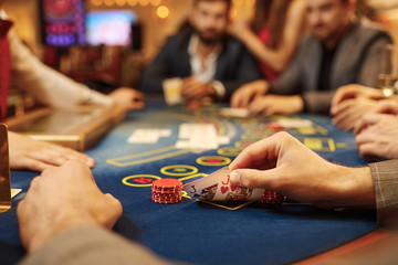 People play poker at the table in the casino.