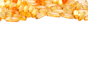 yellow vitamins pills texture close-up from above, medical concept, on white background