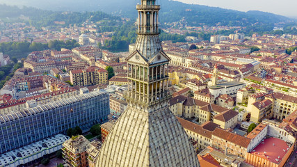 Turin, Italy. Flight over the city. Mole Antonelliana - a 19th-century building with a 121 m high dome and a spire, Aerial View - obrazy, fototapety, plakaty