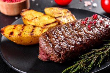 Ribeye steak with potatoes, onions and cherry tomatoes