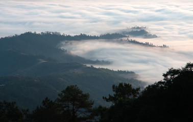 Swirling sea of fog over a valley in a morning