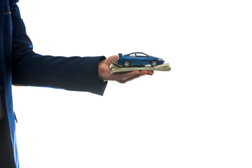 businessman hold toy car and us money for sale or rent car isolated on white.