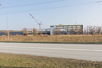 Fototapeta na wymiar City Riga, Latvia. A large building is being built, transport and structures are visible.