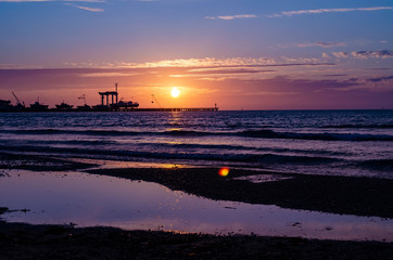 Marina and ships against the background of sunset and seagulls
