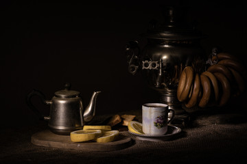 cup of coffee with grinder and cup of coffee on black background